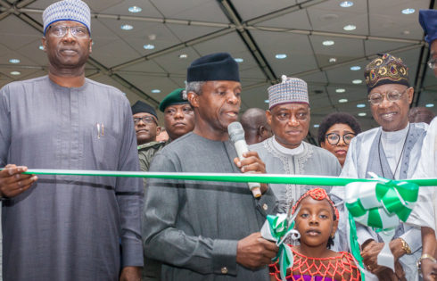 VP Osinbajo flanked by Secretary to the Government of the Federation, Boss Mustapha(L), Hon. Min of Defence, Mansur Dan Ali (1R); Hon. Min of Information & Culture; Lai Mohammed (R). as he cuts the tape to declare exhibition open.